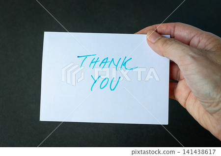 Hand holding a thank you card Hand holding a thank you card 141438617