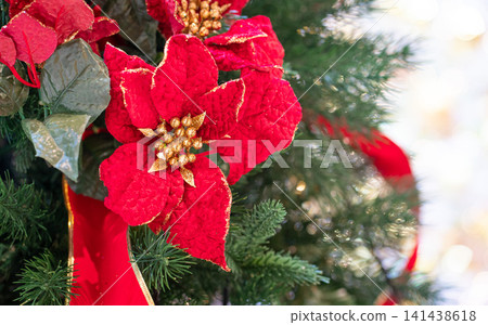 Christmas red flower ornament hanging on tree. Christmas red flower ornament hanging on tree. 141438618
