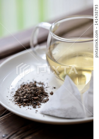 Water chestnut tea leaves and triangular tea bags placed on the windowsill; a caffeine-free health tea. Water chestnut tea leaves and triangular tea bags placed on the windowsill; a caffeine-free health tea. 141438793