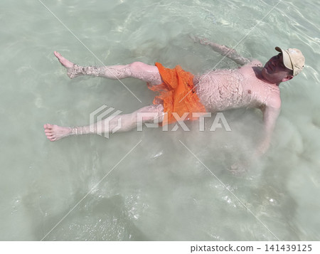 man gracefully swims shallow sea waters showcasing effortless technique carefree spirit while sunlit ripples dance around him vivid snapshot summer freedom athletic poise pure joy being immersed natu 141439125