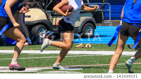 Flag Football Players Run on the Field During a Flag Football Game Flag Football Players Run on the Field During a Flag Football Game 141439331