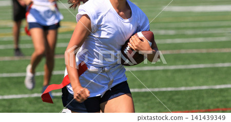 Young Female AthletesRunning Fast During a Flag Football Game Young Female AthletesRunning Fast During a Flag Football Game 141439349