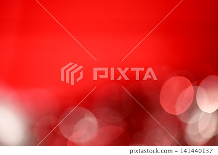 A Christmas background with a red background and white bokeh effects. A Christmas background with a red background and white bokeh effects. 141440137