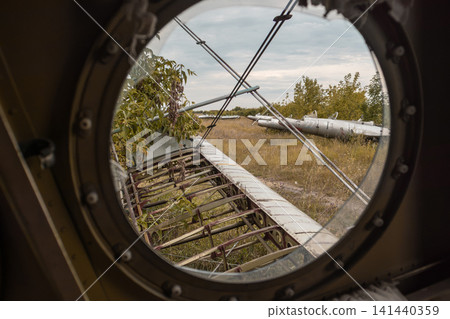 View Through Vintage Broken Aircraft Porthole View Through Vintage Broken Aircraft Porthole 141440359
