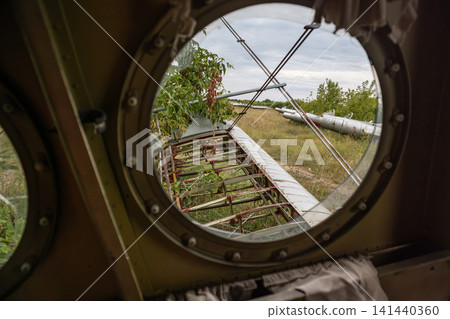View Through Vintage Broken Aircraft Porthole View Through Vintage Broken Aircraft Porthole 141440360