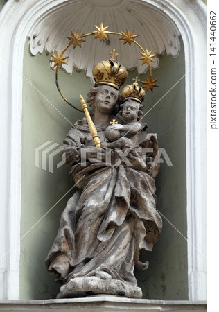 Virgin Mary with baby Jesus, statue on the house facade in Graz, Styria, Austria Virgin Mary with baby Jesus, statue on the house facade in Graz, Styria, Austria 141440662