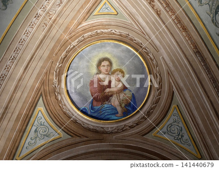 Virgin Mary with baby Jesus, ceiling fresco in the church of St. Victor on the Fishermen Island, one of the famous Borromeo Islands of Lake Maggiore, Italy Virgin Mary with baby Jesus, ceiling fresco in the church of St. Victor on the Fishermen Island, one of the famous Borromeo Islands of Lake Maggiore, Italy 141440679