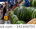 Lots of watermelons in the city market. 141440705