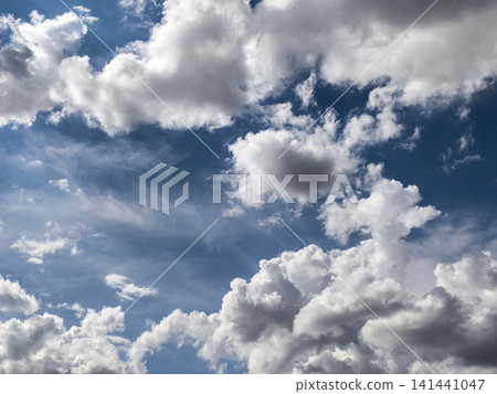 Bright Blue Sky Framed by White Cumulus Clouds Bright Blue Sky Framed by White Cumulus Clouds 141441047