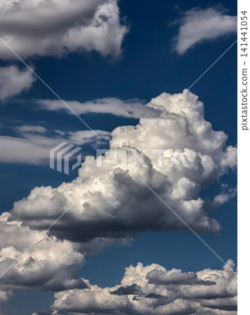 Towering White Cumulus Clouds Rising Into Deep Blue Sky Towering White Cumulus Clouds Rising Into Deep Blue Sky 141441054
