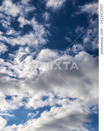 Layered Cumulus and Wispy Clouds Across Deep Blue Sky Layered Cumulus and Wispy Clouds Across Deep Blue Sky 141441065
