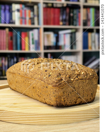 Fresh Keto Seed Bread Loaf Displayed on Wooden Board Fresh Keto Seed Bread Loaf Displayed on Wooden Board 141441070