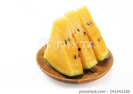 A sliced yellow watermelon against a white background. A sliced yellow watermelon against a white background. 141442280