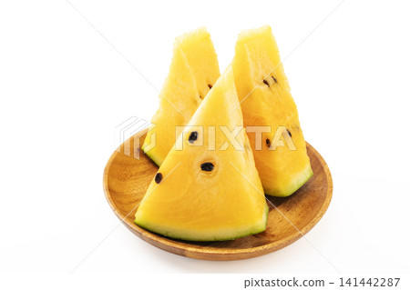 A sliced yellow watermelon against a white background. A sliced yellow watermelon against a white background. 141442287