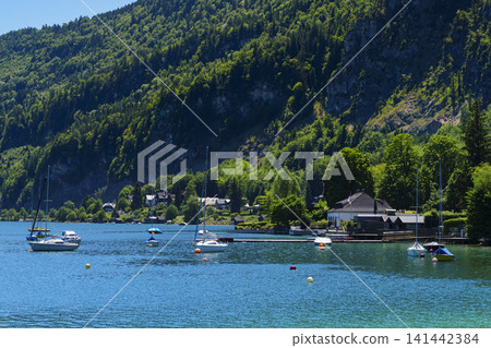 Sailboats on Lake Wolfgangsee in the Salzkammergut, illustrating scenic lake tourism in Austria and classic alpine summer vibe. Sailboats on Lake Wolfgangsee in the Salzkammergut, illustrating scenic lake tourism in Austria and classic alpine summer vibe. 141442384