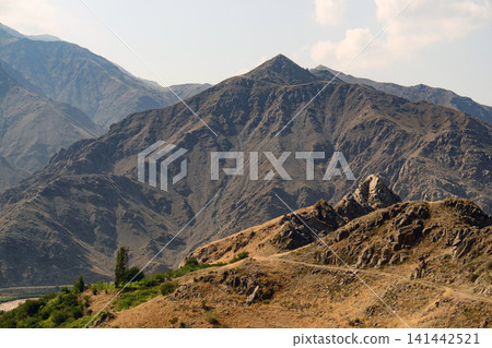 Rugged mountain peak with dry earth tones Rugged mountain peak with dry earth tones 141442521