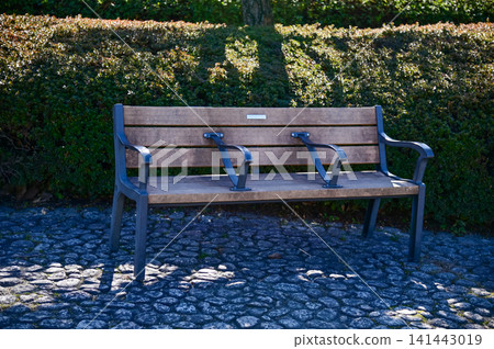 A bench in the public park in Nagoya, Japan. Empty bench in the park in Nagoya. For leisure, relax, resting. A bench in the public park in Nagoya, Japan. Empty bench in the park in Nagoya. For leisure, relax, resting. 141443019