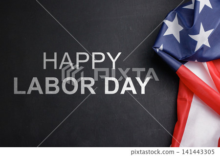 Happy Labor Day text displayed on a dark wooden surface featuring a draped American flag on the right side with copy space. High Quality Photo Happy Labor Day text displayed on a dark wooden surface featuring a draped American flag on the right side with copy space. High Quality Photo 141443305