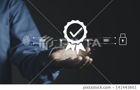Hand holding glowing quality certification seal, fingerprint and padlock icon. Concept of identity verification, biometric security, professional trust, and digital compliance standards. Hand holding glowing quality certification seal, fingerprint and padlock icon. Concept of identity verification, biometric security, professional trust, and digital compliance standards. 141443601