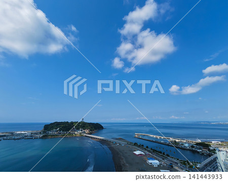 A photo taken from a high vantage point at Katase Higashihama Beach, showing Enoshima Island surrounded by the sea and the sandy beach. A photo taken from a high vantage point at Katase Higashihama Beach, showing Enoshima Island surrounded by the sea and the sandy beach. 141443933