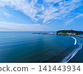 A photo taken from a high vantage point at Katase Higashihama Beach, showing Enoshima Island surrounded by the sea and the sandy beach. 141443934