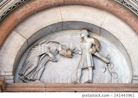 The right portal of the Cathedral of St Martin in Lucca. Lunette depicts the Beheading of Saint Regulus, Lucca, Italy. The right portal of the Cathedral of St Martin in Lucca. Lunette depicts the Beheading of Saint Regulus, Lucca, Italy. 141443961