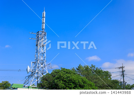 A television broadcasting station's transmission tower stands tall against the clear blue sky. A television broadcasting station's transmission tower stands tall against the clear blue sky. 141443988