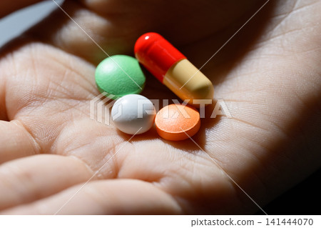 Hands to pick up the medicine Hands to pick up the medicine 141444070