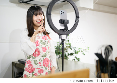 Japanese woman taking photos of food with her smartphone 141444106