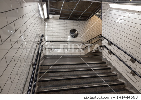 Subway station staircase with white tiled walls Subway station staircase with white tiled walls 141444568