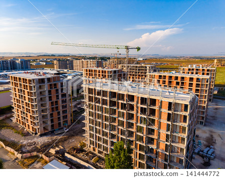 Construction of residential buildings in urban area during daytime Construction of residential buildings in urban area during daytime 141444772