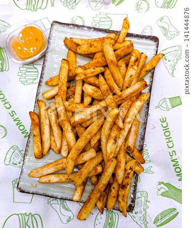 Crispy Golden French Fries with Spicy Sauce Dip 141444876