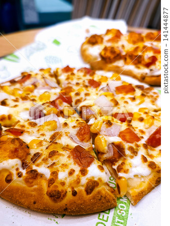 Delicious Freshly Baked Pizza with Toppings on a Plate 141444877