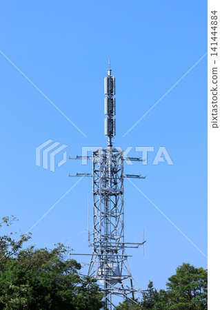 A television broadcasting station's transmission tower stands tall against the clear blue sky. A television broadcasting station's transmission tower stands tall against the clear blue sky. 141444884
