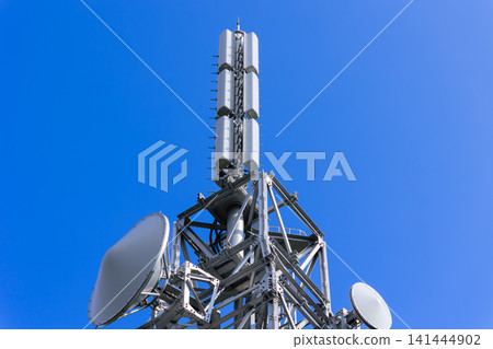 A television broadcasting station's transmission tower stands tall against the clear blue sky. A television broadcasting station's transmission tower stands tall against the clear blue sky. 141444902