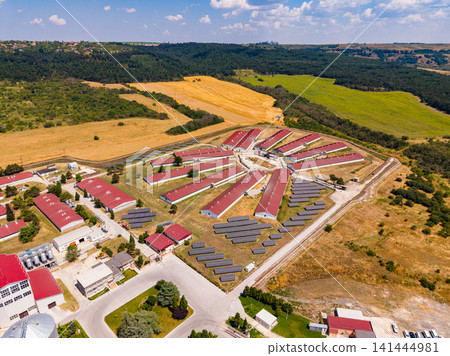 Aerial view of a farm with buildings and fields in the countryside on a sunny day Aerial view of a farm with buildings and fields in the countryside on a sunny day 141444981