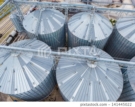 Large steel silos used for grain storage at a processing facility during daytime Large steel silos used for grain storage at a processing facility during daytime 141445022