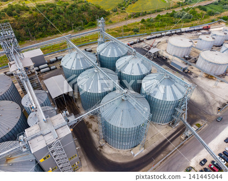 Industrial storage area with grain silos and transport tracks in a rural setting Industrial storage area with grain silos and transport tracks in a rural setting 141445044