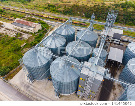 Silos located beside a railway track in a warehouse area showing storage and transport of grain Silos located beside a railway track in a warehouse area showing storage and transport of grain 141445045