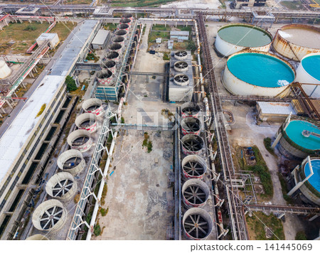 Industrial site with large tanks and equipment located in a manufacturing area during daylight hours 141445069