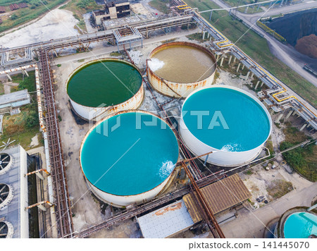 Water treatment facility in operation with large tanks in various colors Water treatment facility in operation with large tanks in various colors 141445070