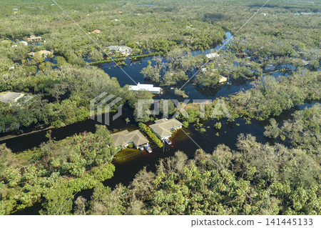 Heavy flood with high water surrounding residential houses after hurricane Ian rainfall in Florida residential area. Consequences of natural disaster Heavy flood with high water surrounding residential houses after hurricane Ian rainfall in Florida residential area. Consequences of natural disaster 141445133