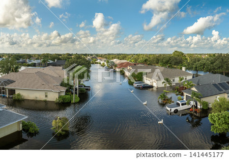Flooded cars and houses from hurricane rainfall water in Florida residential community. Aftermath of natural disaster in USA south 141445177