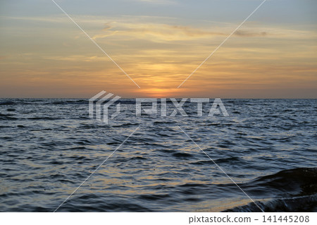 Dramatic red ocean waves at sunset with soft evening sea dark water Dramatic red ocean waves at sunset with soft evening sea dark water 141445208