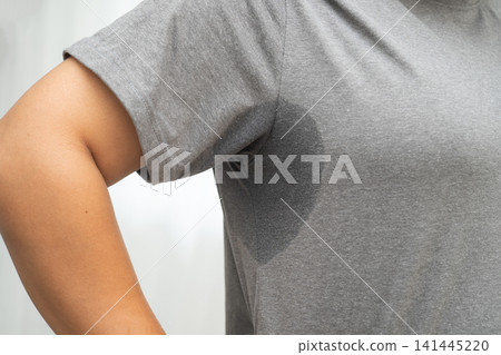 Sweaty underarms, Asian woman with sweat on clothes under armpit. Sweaty underarms, Asian woman with sweat on clothes under armpit. 141445220