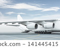 Loading a white big heavy cargo airplane. The rear cargo compartment is open 141445415