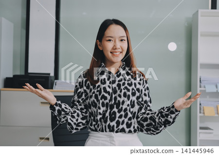 Confident asian business woman standing in modern office Confident asian business woman standing in modern office 141445946