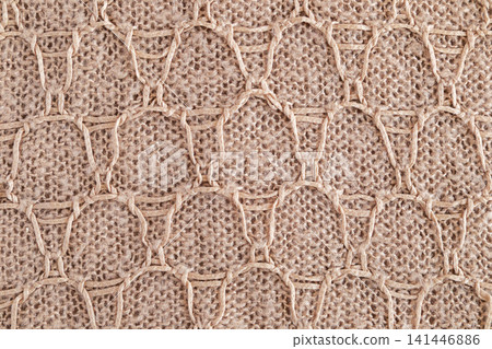 Beige woven jute knit with macrame honeycomb pattern and natural rope texture for decor Beige woven jute knit with macrame honeycomb pattern and natural rope texture for decor 141446886