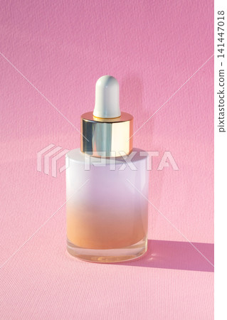 Minimal pink serum bottle with gold dropper cap for skincare product and beauty branding Minimal pink serum bottle with gold dropper cap for skincare product and beauty branding 141447018