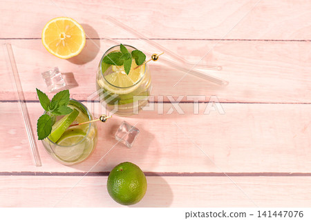Refreshing summer drink, homemade lemonade, juice or cocktail with ice, mint, lime, lemon and citrus, a detox diet and weight loss concept, a restaurant or cafe menu, nonalcoholic mojito for energy Refreshing summer drink, homemade lemonade, juice or cocktail with ice, mint, lime, lemon and citrus, a detox diet and weight loss concept, a restaurant or cafe menu, nonalcoholic mojito for energy 141447076